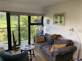 A living room with a sofa and table at The Sett on the Wharfe in Skipton