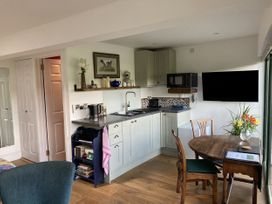 A kitchen with a table and chairs at The Sett on the Wharfe in Skipton