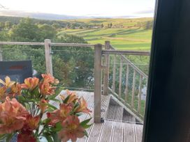 A balcony with flowers and view of landscape at The Sett on the Wharfe Skipton