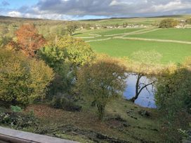 A view of a river and trees at The Sett on the Wharfe in Skipton
