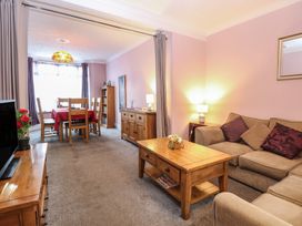 A living room with a sofa and dining area at 4 Trafalgar Square, Great Yarmouth