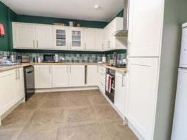 A kitchen with cabinets and appliances at 4 Trafalgar Square in Great Yarmouth