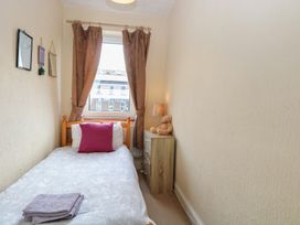 A bedroom with a bed and lamp at 4 Trafalgar Square in Great Yarmouth