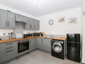A kitchen with grey cabinets and appliances at 76A Mackworth Road Porthcawl