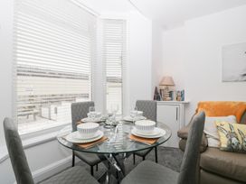A dining room with a glass table and chairs at 76A Mackworth Road in Porthcawl