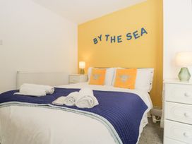 A bedroom with a bed and bedside table at 76A Mackworth Road in Porthcawl