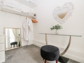 A dressing room with a table and mirror at 76A Mackworth Road in Porthcawl