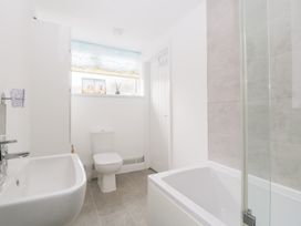 A bathroom with a sink, toilet, and bathtub at 76A Mackworth Road Porthcawl