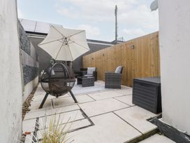 An outdoor area with seating and an umbrella at 76A Mackworth Road Porthcawl