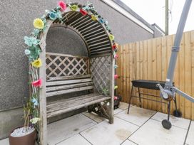 A garden arch with a bench and grill at 76A Mackworth Road Porthcawl