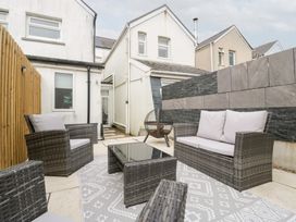 An outdoor seating area with chairs and a table at 76A Mackworth Road Porthcawl