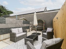 A garden with seating and a table at 76A Mackworth Road Porthcawl