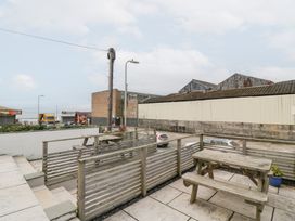 An outdoor area with a table and benches at 76A Mackworth Road Porthcawl