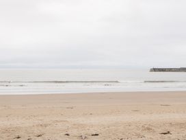 A beach with sand and water at 76A Mackworth Road in Porthcawl