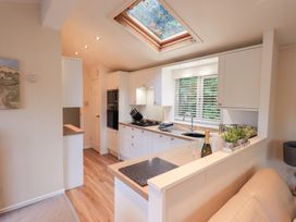 A kitchen with a sink and stove at Acorn Bank Lodge, L 55, Fallbarrow Park near Bowness-On-Windermere