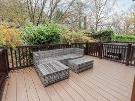 An outdoor area with seating and table at Damson Lodge Thirlmere 8, White Cross Bay, Windermere