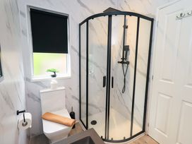A bathroom with a shower and toilet at Rydal Lodge, Grasmere 24, White Cross Bay near Windermere
