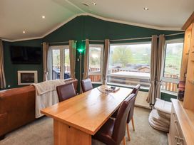 A dining room with a table and chairs at Elder Lodge Kirkstone 5 Limefitt Park near Windermere