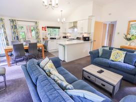 A living room with sofa and dining area at Forest Pines Lodge Beech Hill 10, Fallbarrow Park near Bowness on Windermere