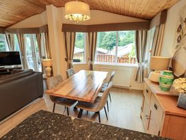 A dining room with a table and chairs at Birthwaite Lodge, Fellside 6, Limefitt Park near Windermere