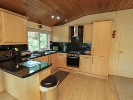 A kitchen with cabinets, sink, and appliances at Birthwaite Lodge, Fellside 6, Limefitt Park near Windermere