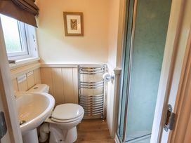 A bathroom with a sink, toilet, and shower at Birthwaite Lodge, Fellside 6, Limefitt Park near Windermere