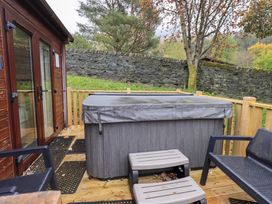 An outdoor space with a hot tub and seating at Robin View Lodge Beckside 3 Limefitt Park near Windermere