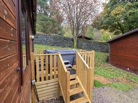 An outdoor area with a deck and hot tub at Robin View Lodge, Beckside 3, Limefitt Park near Windermere