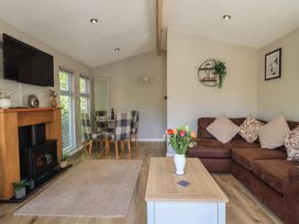 A living room with furniture and a television at Badgers Hollow Lodge Grasmere 30, White Cross Bay near Windermere