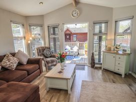A living room with a coffee table and seating area at Badgers Hollow Lodge Grasmere 30 White Cross Bay near Windermere
