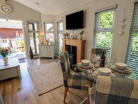 A dining room with a table set for dinner at Badgers Hollow Lodge Grasmere 30, White Cross Bay near Windermere