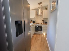 A kitchen with a refrigerator and oven at Badgers Hollow Lodge, Grasmere 30, White Cross Bay near Windermere