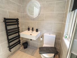 A bathroom with a sink and toilet at Badgers Hollow Lodge Grasmere 30, White Cross Bay near Windermere