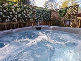 A hot tub with water and bubbles at Badgers Hollow Lodge in Grasmere 30, White Cross Bay near Windermere