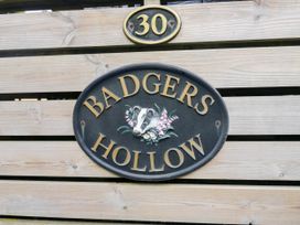 A sign that reads BADGERS HOLLOW with number 30 at Badgers Hollow Lodge, Grasmere 30, White Cross Bay near Windermere