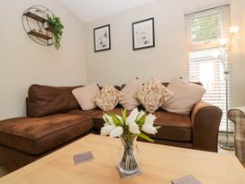 A living room with a sofa and a coffee table at Badgers Hollow Lodge in Grasmere 30, White Cross Bay near Windermere