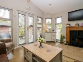 A living room with a coffee table and sofa at Badgers Hollow Lodge Grasmere 30, White Cross Bay near Windermere