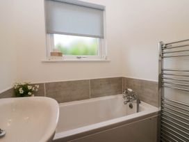 A bathroom with a bathtub and sink at Badgers Hollow Lodge Grasmere 30, White Cross Bay near Windermere