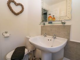 A bathroom with a sink and toilet at Badgers Hollow Lodge in Grasmere 30, White Cross Bay near Windermere