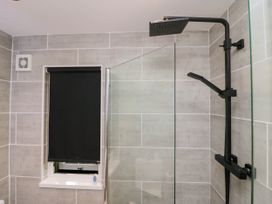 A bathroom with a shower and a window at Badgers Hollow Lodge in Grasmere 30, White Cross Bay near Windermere