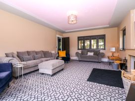 A living room with furniture arranged around a coffee table at Thornbury, Barnard's Green, Malvern