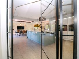 A kitchen with an island and dining area at Thornbury in Barnard's Green, Malvern