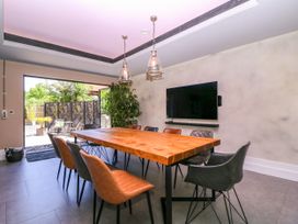 A dining room with a wooden table and chairs at Thornbury, Barnard's Green, Malvern