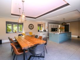 A kitchen with a table and chairs at Thornbury in Barnard's Green, Malvern