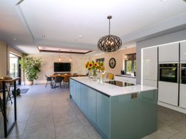 A kitchen with a large island and dining area at Thornbury in Barnard's Green, Malvern