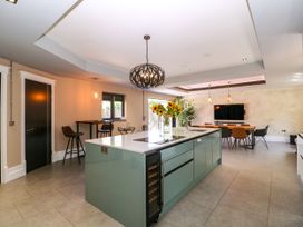 A kitchen with an island and dining area at Thornbury, Barnard's Green, Malvern