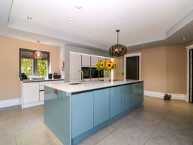 A kitchen with an island and a sink at Thornbury in Barnard's Green, Malvern