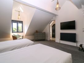 A bedroom with two beds and a television at Thornbury, Barnard's Green, Malvern