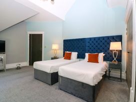 A bedroom with two beds and a television at Thornbury in Barnard's Green, Malvern