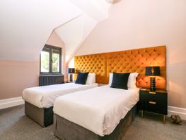 A bedroom with two beds and a window at Thornbury, Barnard's Green, Malvern